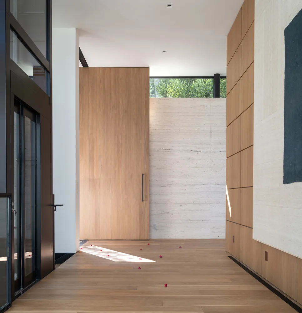Entryway featuring wooden and marble materials with a minimalist design.