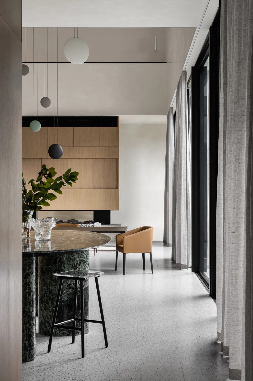 A modern living room featuring marble and glass elements.