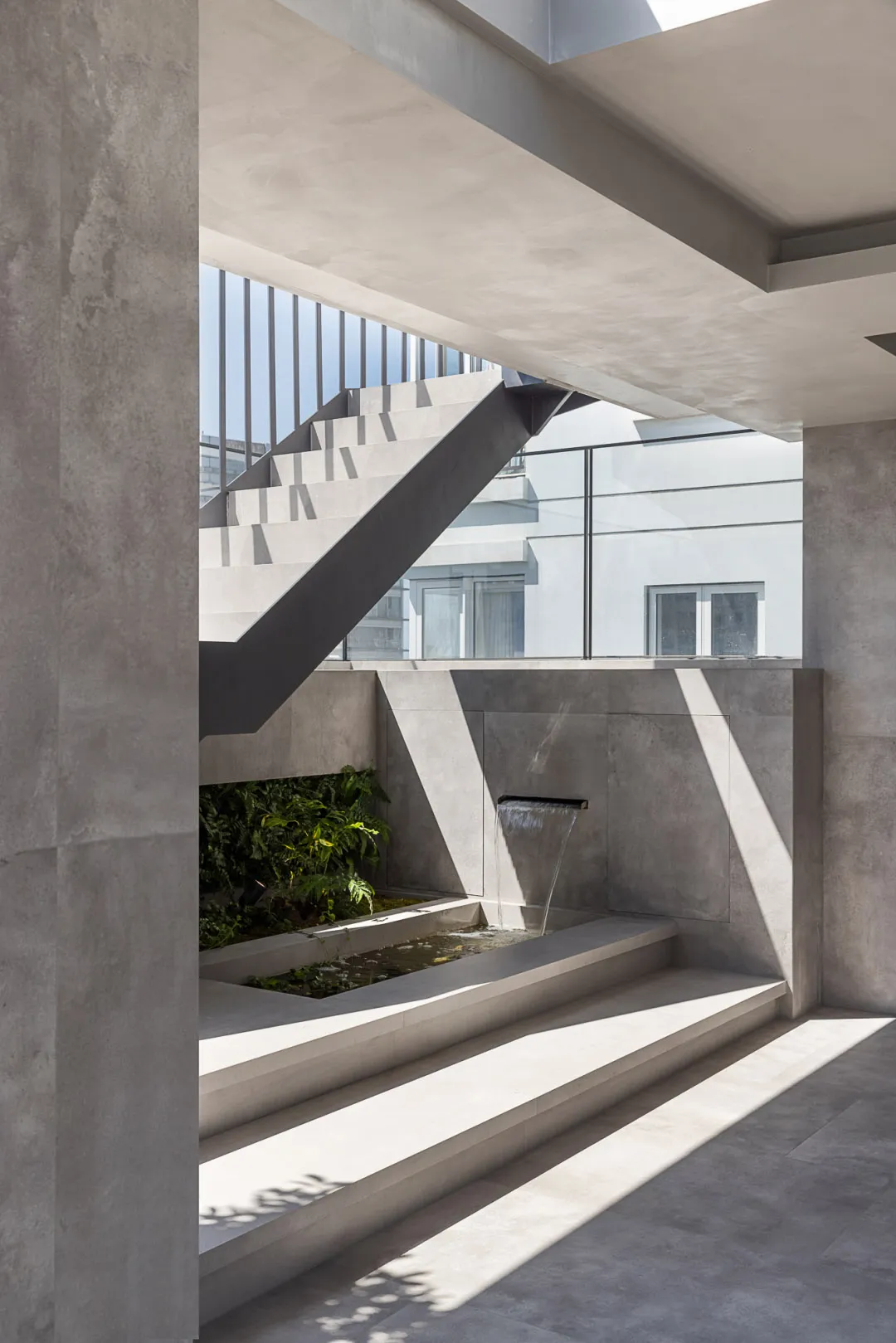 Modern indoor architecture featuring minimalist design and concrete materials.
