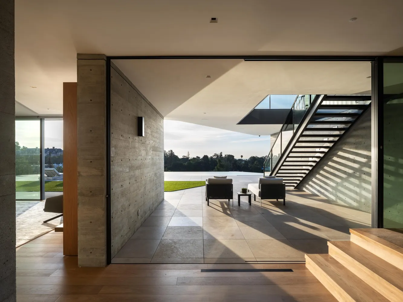 Modern residential interior featuring concrete and glass materials.