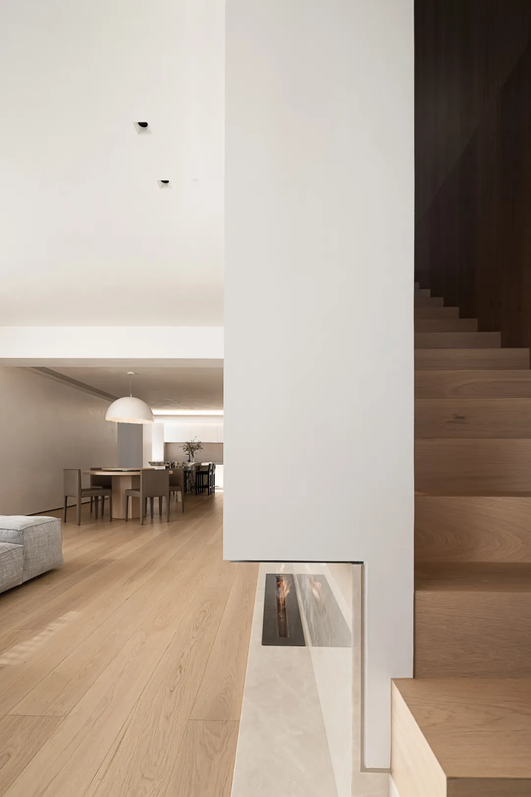 Modern living room with wooden floor and furniture, minimalist design.