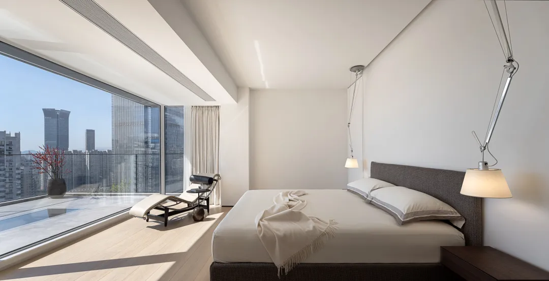 Modern interior design featuring glass windows and wooden flooring.