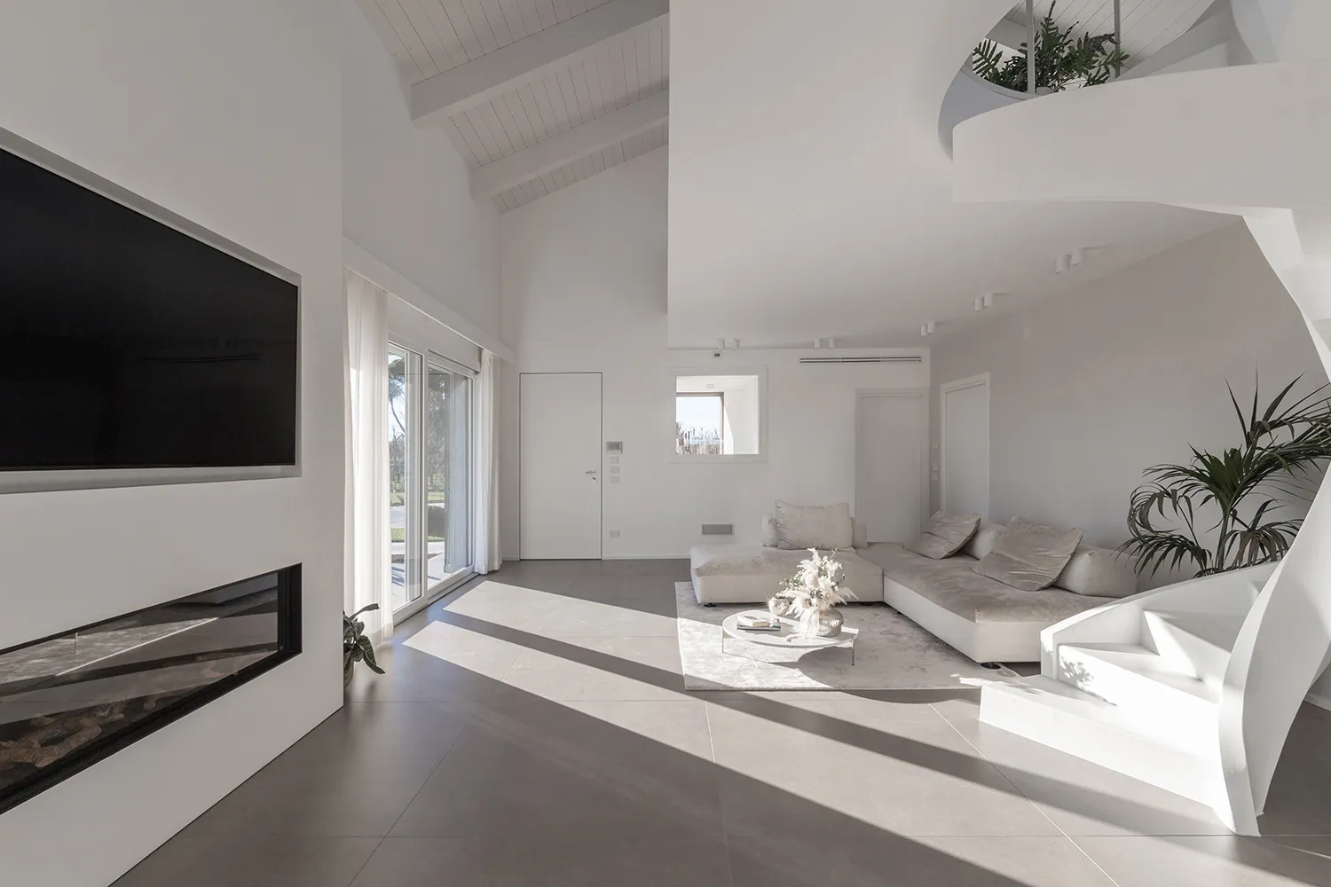 Modern minimalist living room featuring concrete flooring and minimalist furniture.