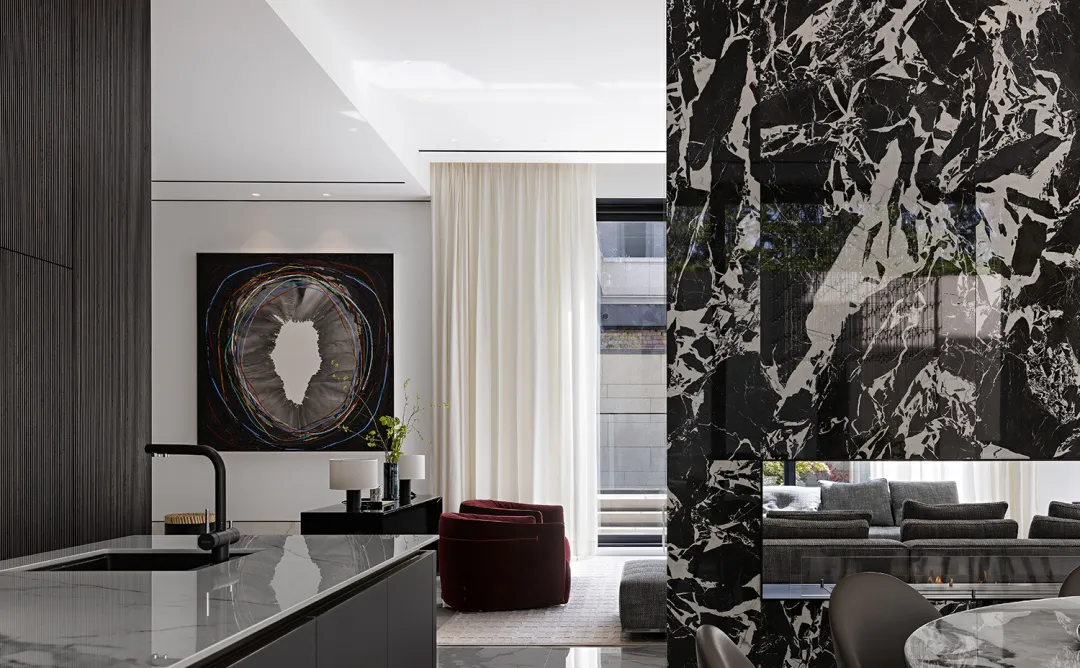 Modern interior design with black marble flooring and walls, contemporary furniture, and abstract art.