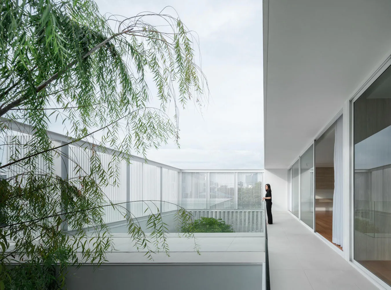 Modern high-rise living room with large window frame and white tile flooring