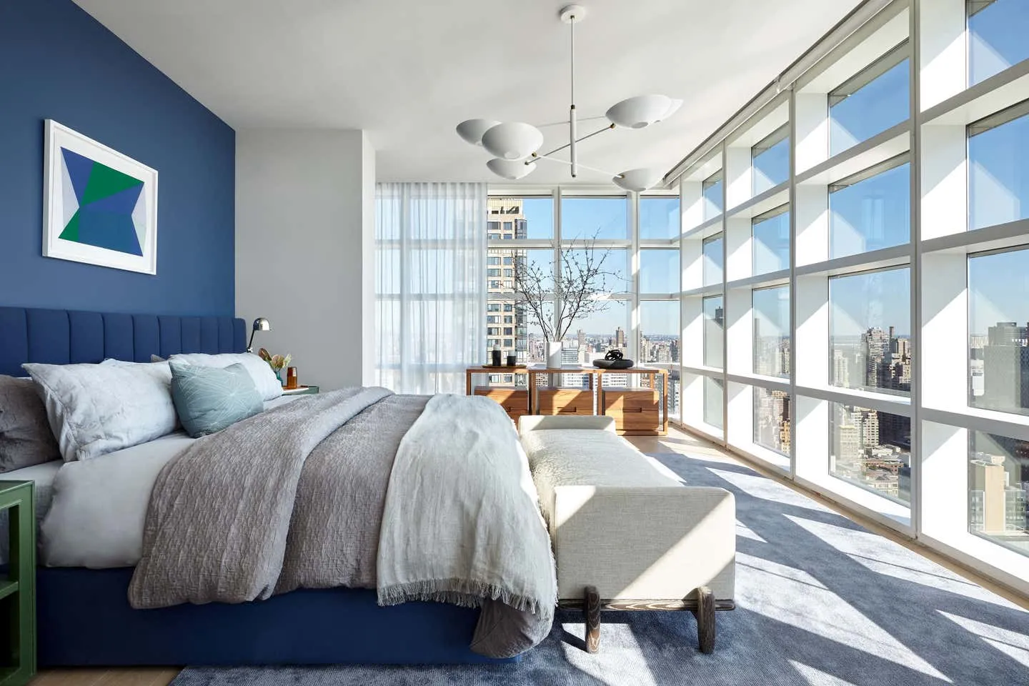 Modern minimalist bedroom with gray and glass elements.