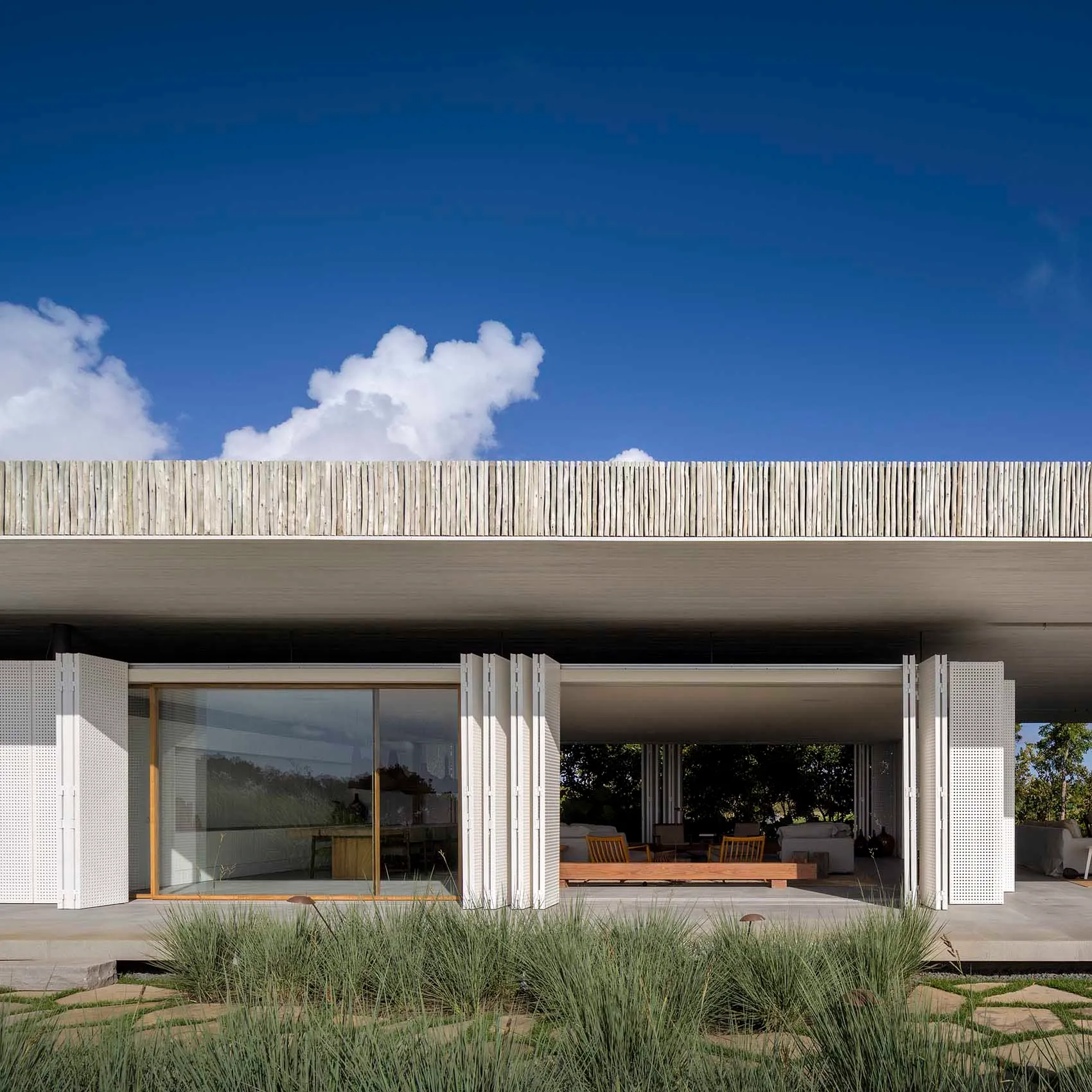 A minimalist residential home featuring concrete and glass materials.