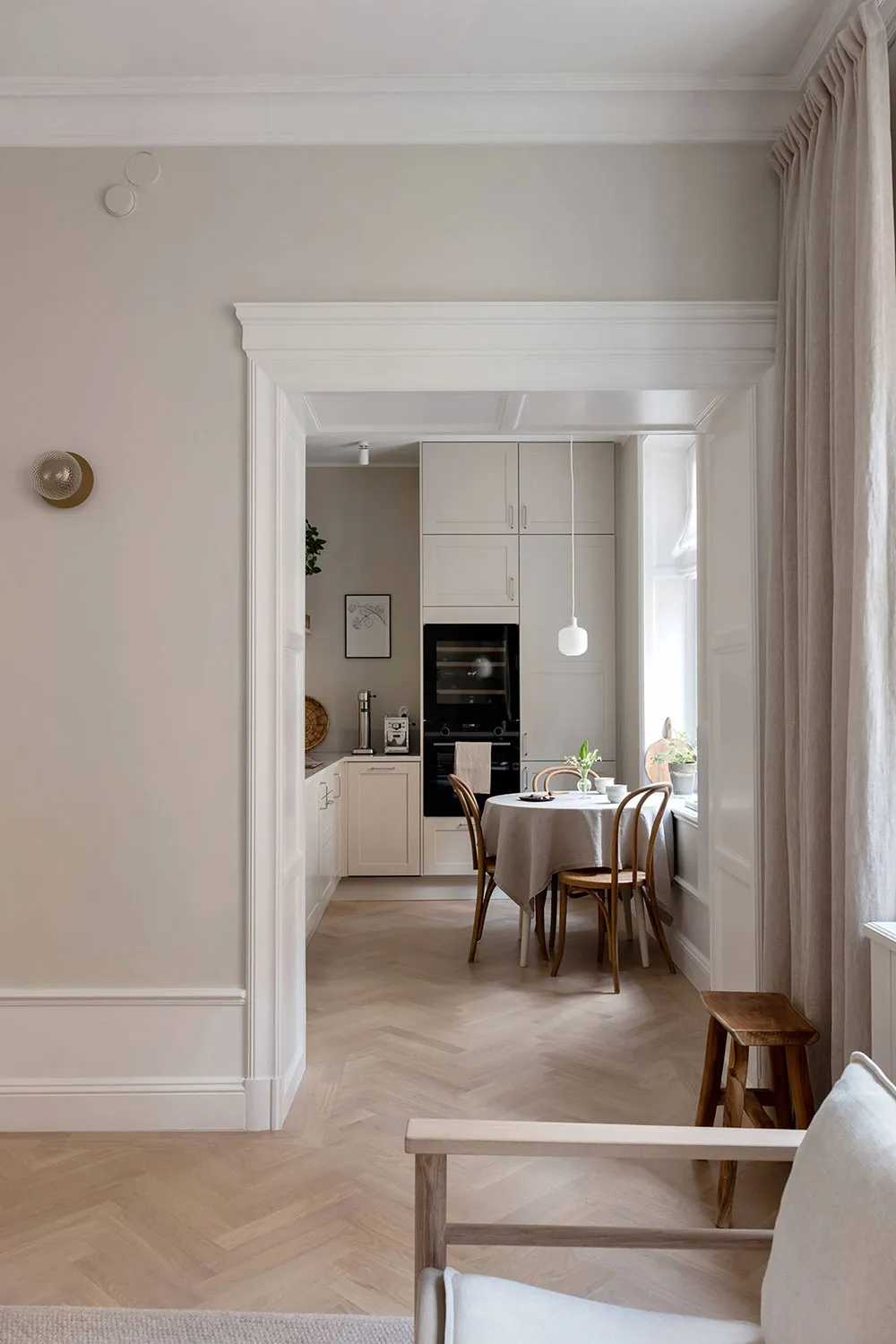 A minimalist residential kitchen featuring light wood finishes.