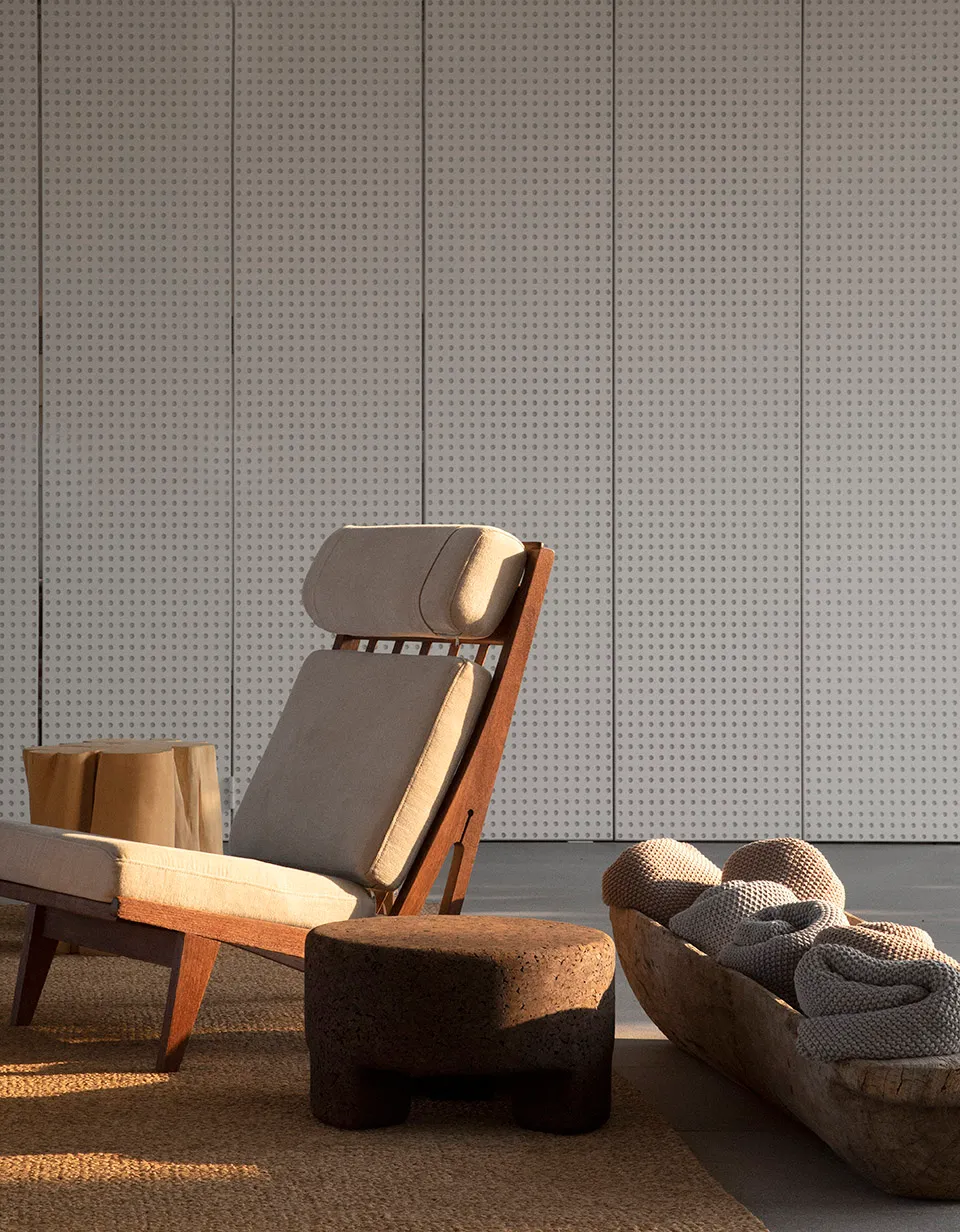 Modern lounge chair with cushions and footstool.