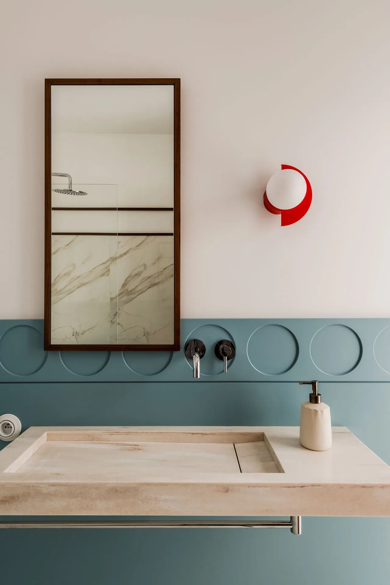 Modern bathroom with marble sink and minimalist design elements.