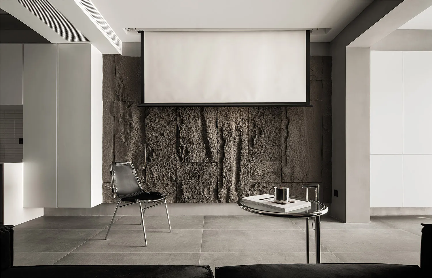 Modern living room featuring a concrete and metal interior design