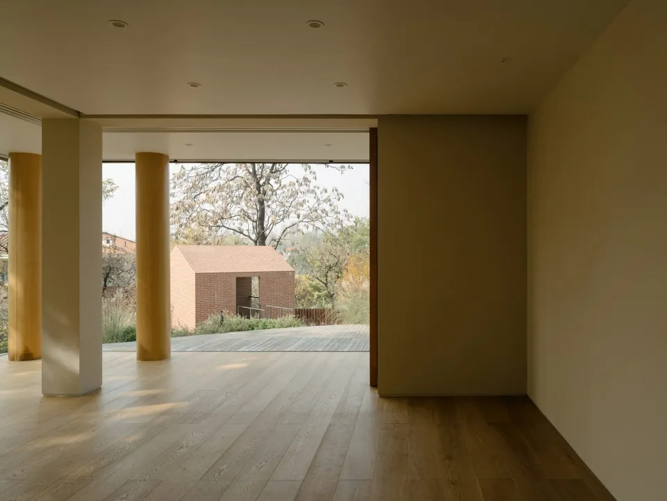 A modern residential interior showcasing wood flooring and natural light.
