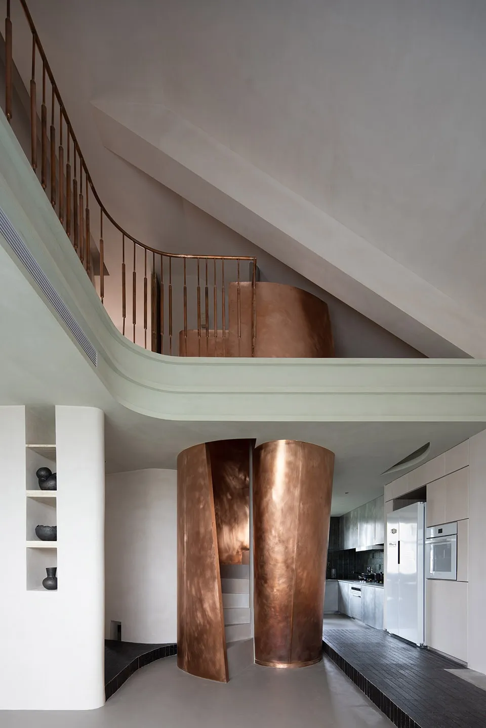 Modern kitchen with copper finish and minimalist design.