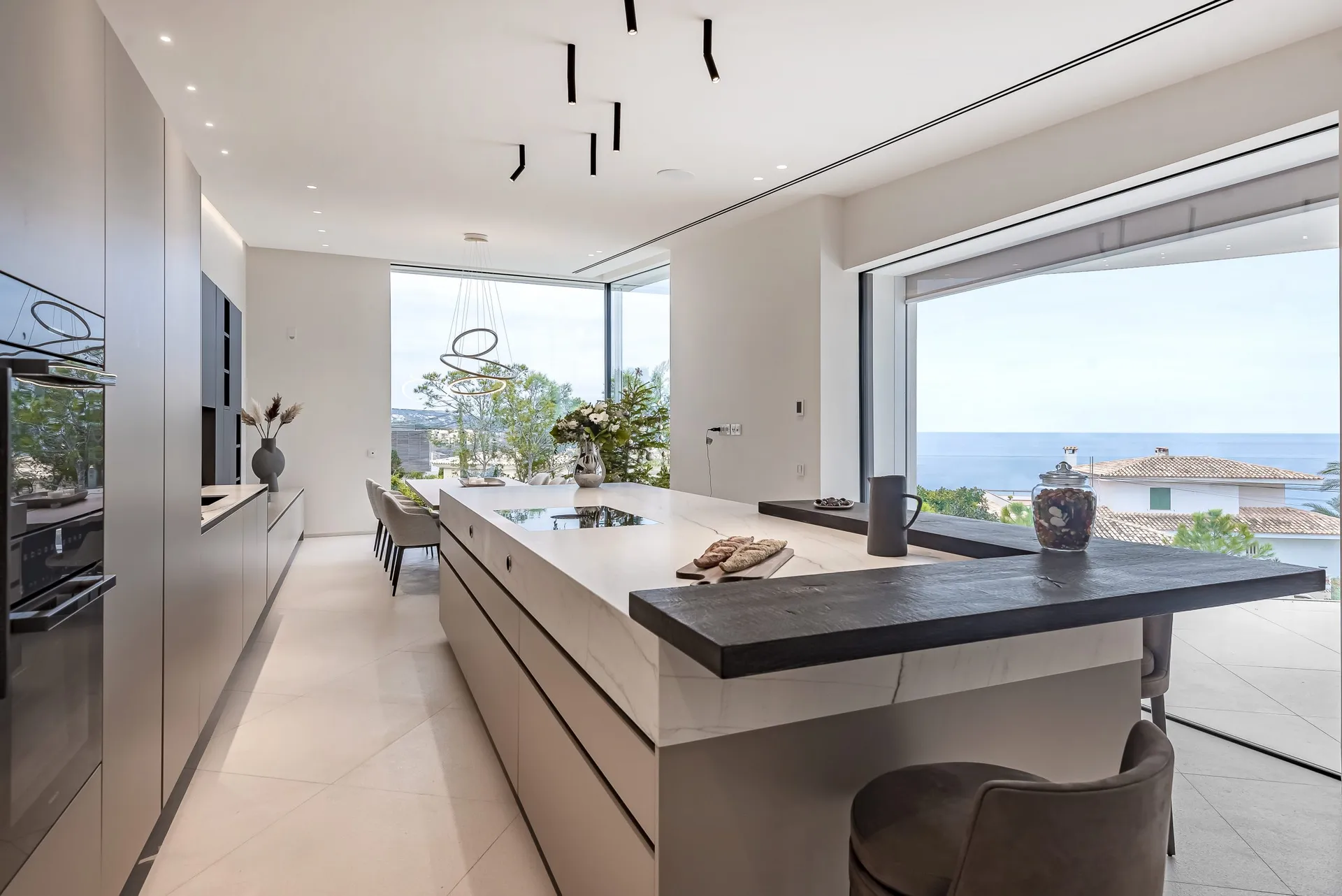 Modern minimalist kitchen with marble countertops, islands, and minimalist fixtures and fittings.