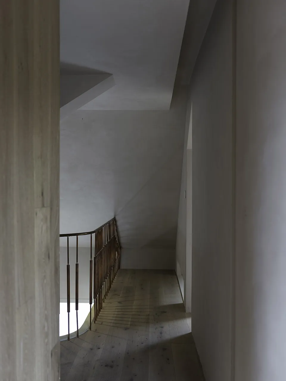 Modern, industrial-style staircase featuring wood flooring and metal railings.