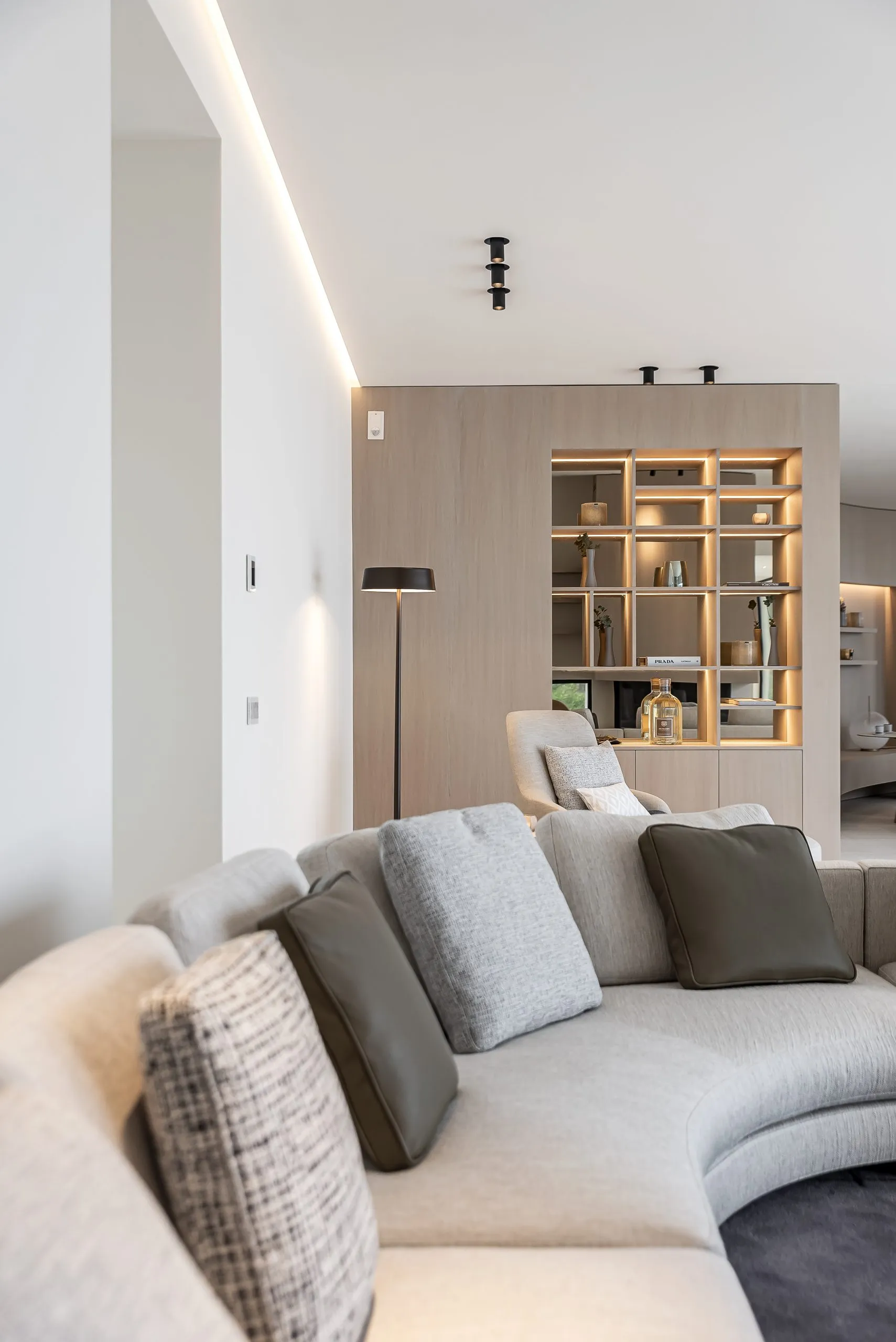 A modern living room with neutral-toned furnishings and minimalist decor.