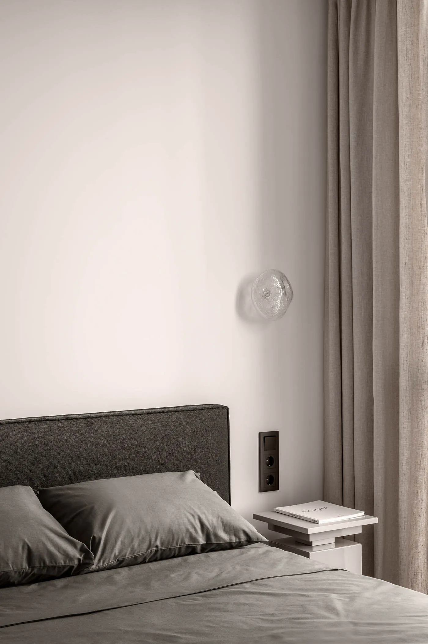 Neutral materials in a minimalist bedroom setting.