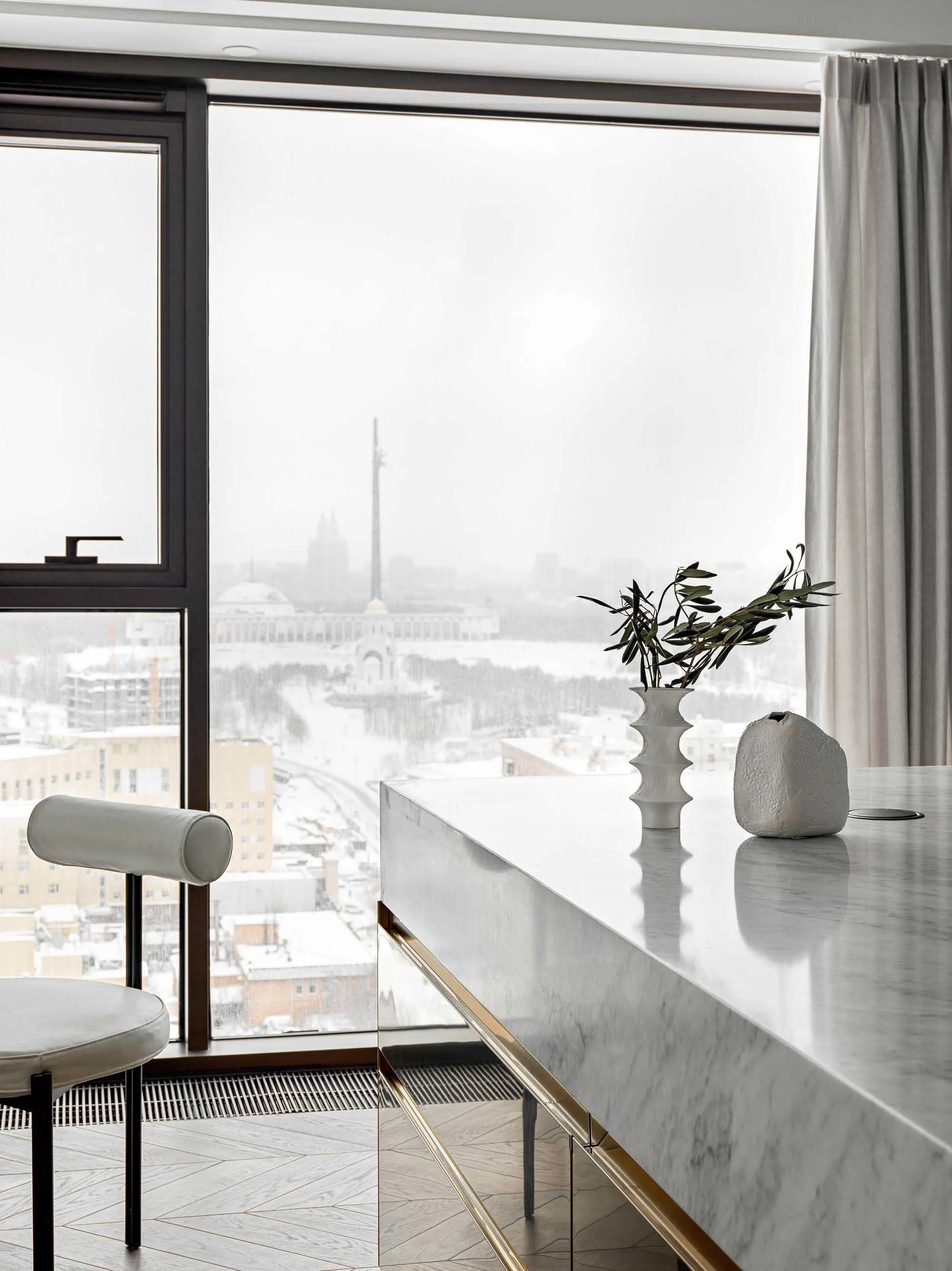 Modern kitchen with a marble countertop featuring sleek, minimalist design.