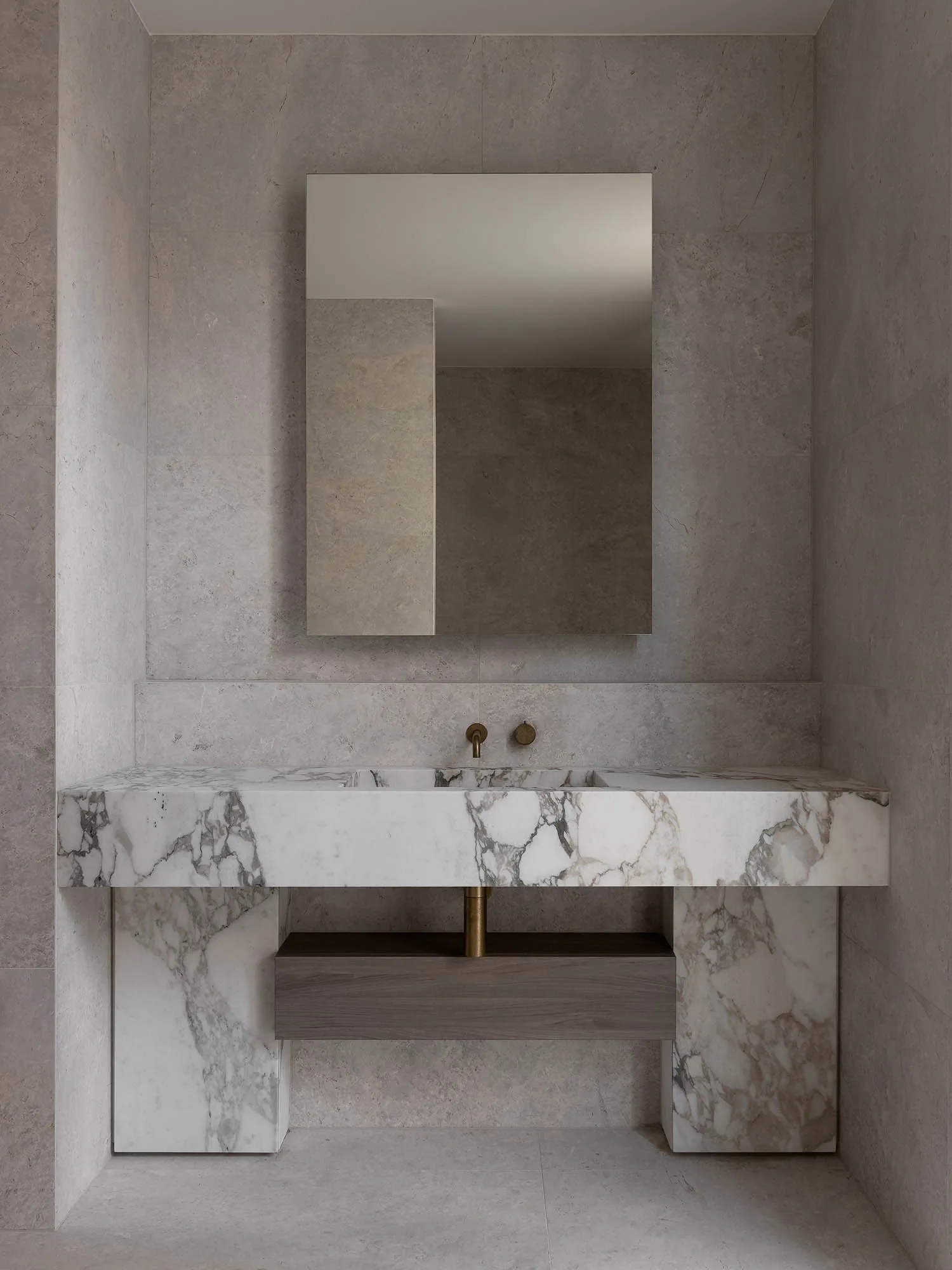 A minimalist bathroom with marble accents and a floating vanity.