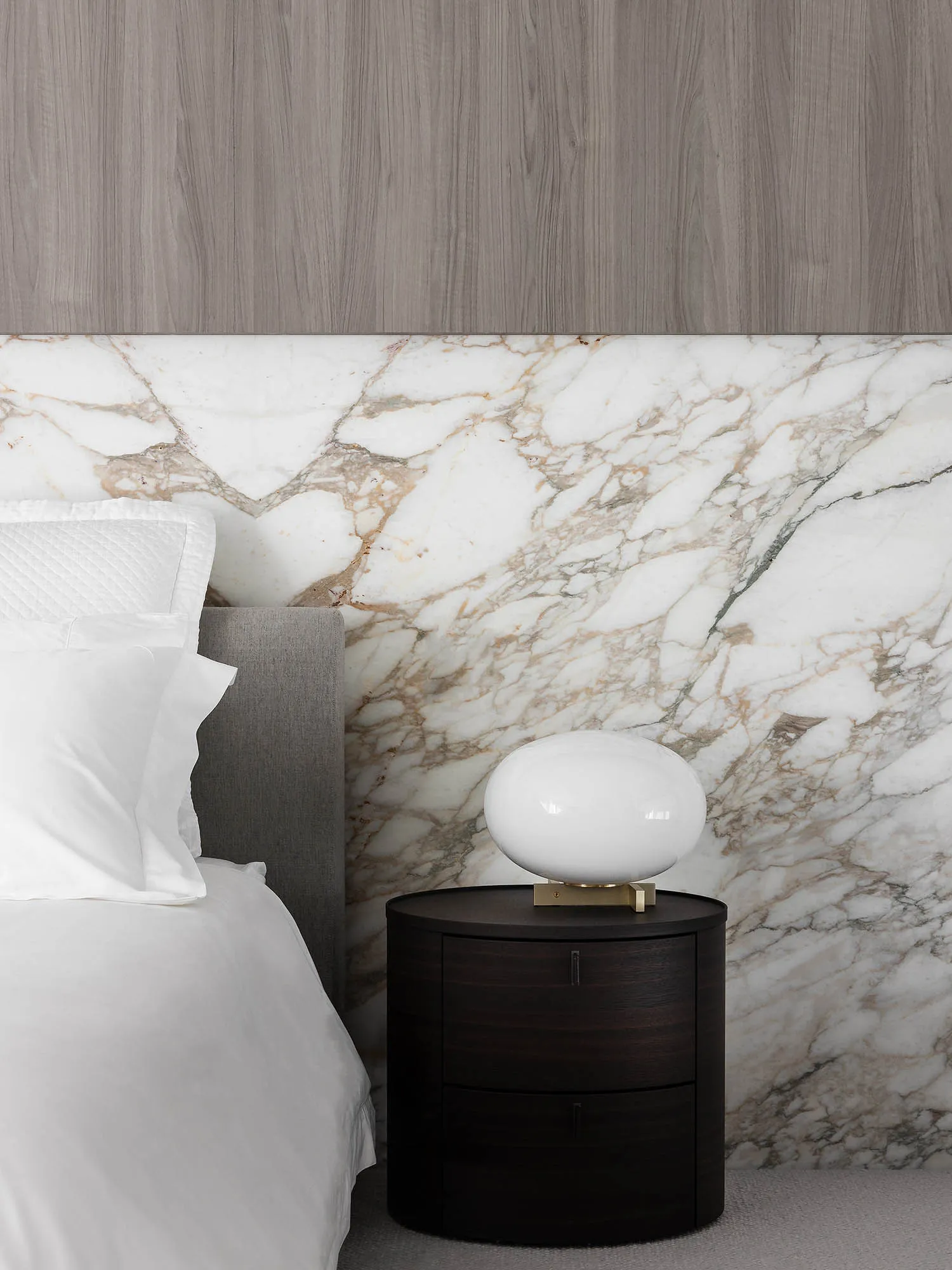 A modern marble bedroom featuring a side table with a black finish.