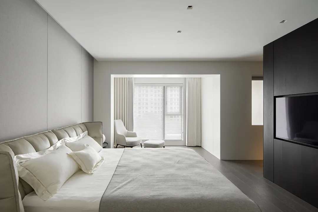 A modern neutral-themed bedroom with minimalist decor and a sleek, contemporary design.