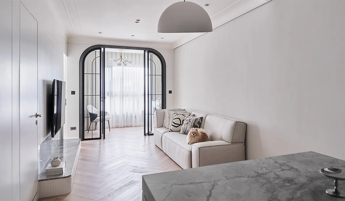 A modern living room featuring neutral tones and minimalist furniture.