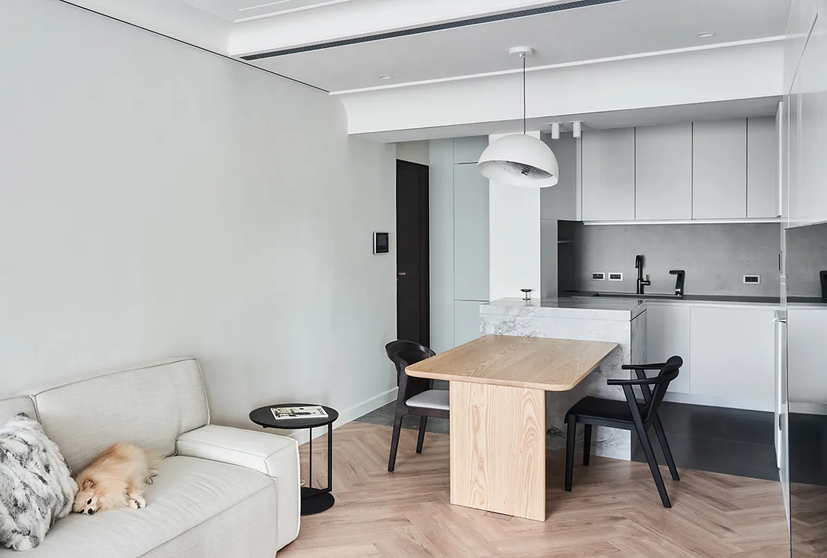 A modern interior space featuring white walls, flooring, and furniture.