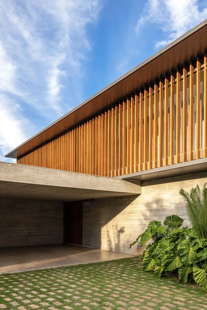 A modern exterior building with horizontal wooden slats and a concrete base.