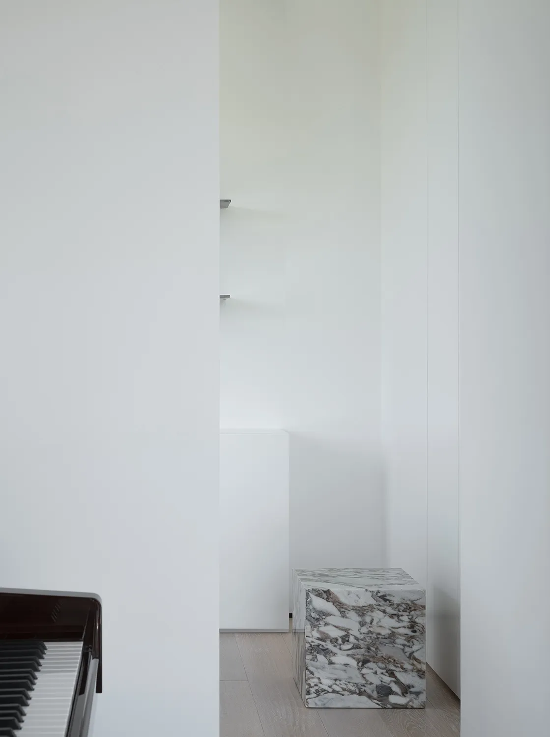 Minimalist interior design featuring marble accents and wood finishes.