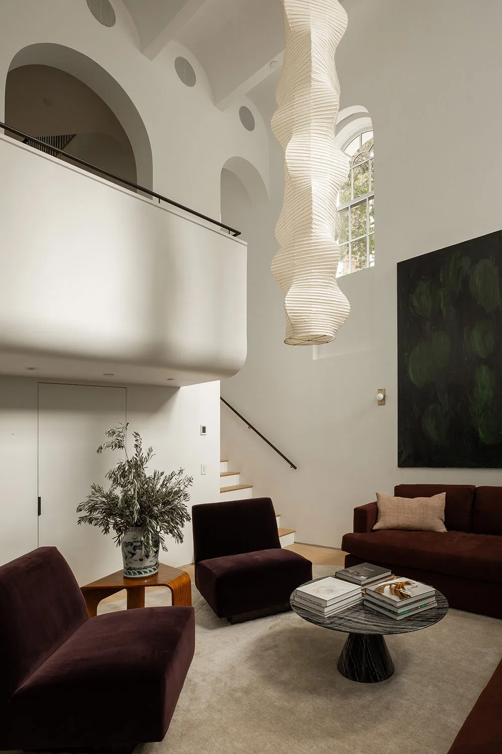 A modern living room featuring a combination of marble and concrete materials.