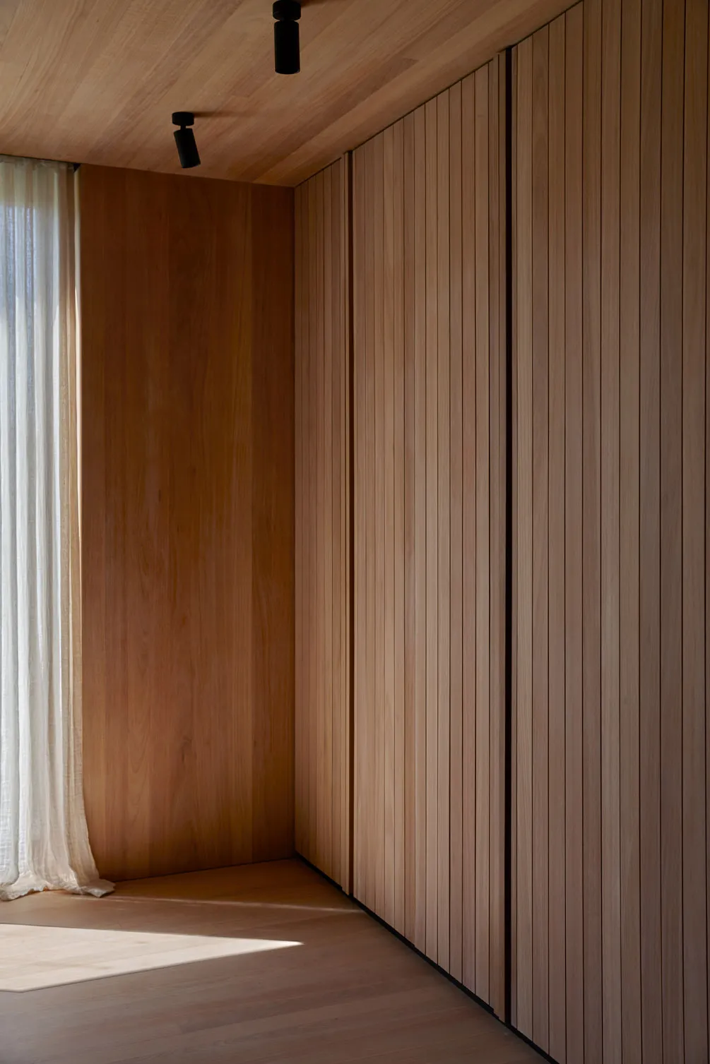 Modern interior design featuring wooden walls and ceiling.