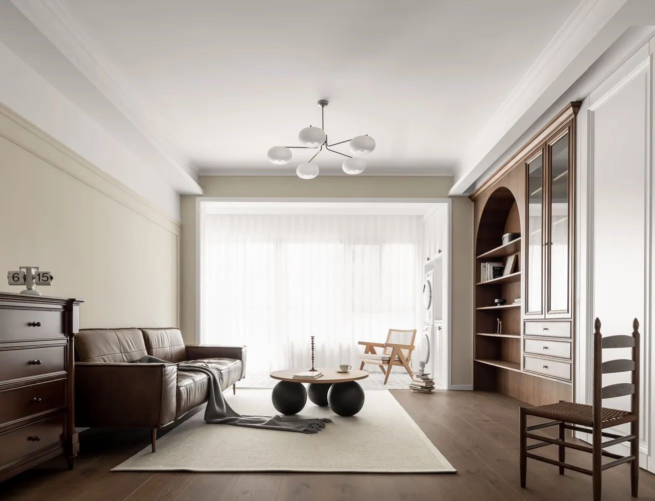 A minimalist living room with a leather sofa, wooden coffee table, and glass globe chandelier.