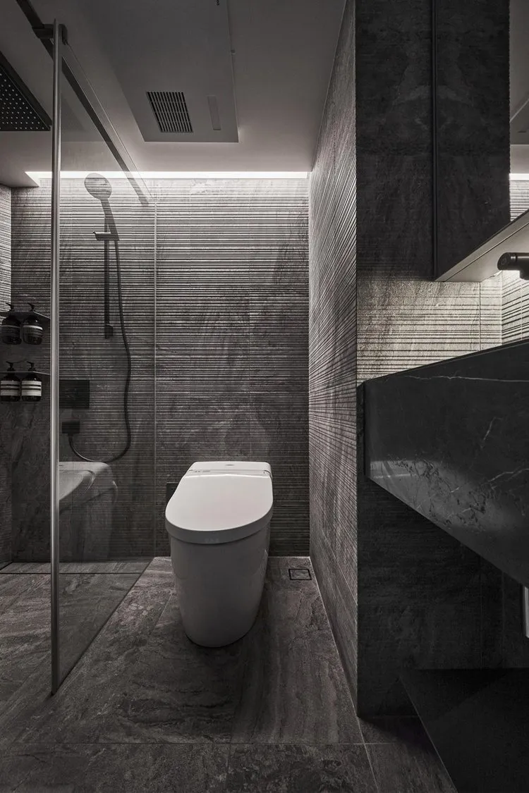Modern bathroom featuring marble tiles and fixtures