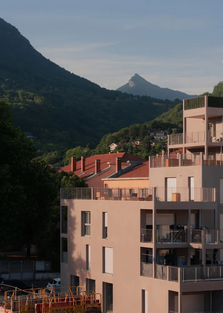 A modern residential building with concrete façade and balconies.