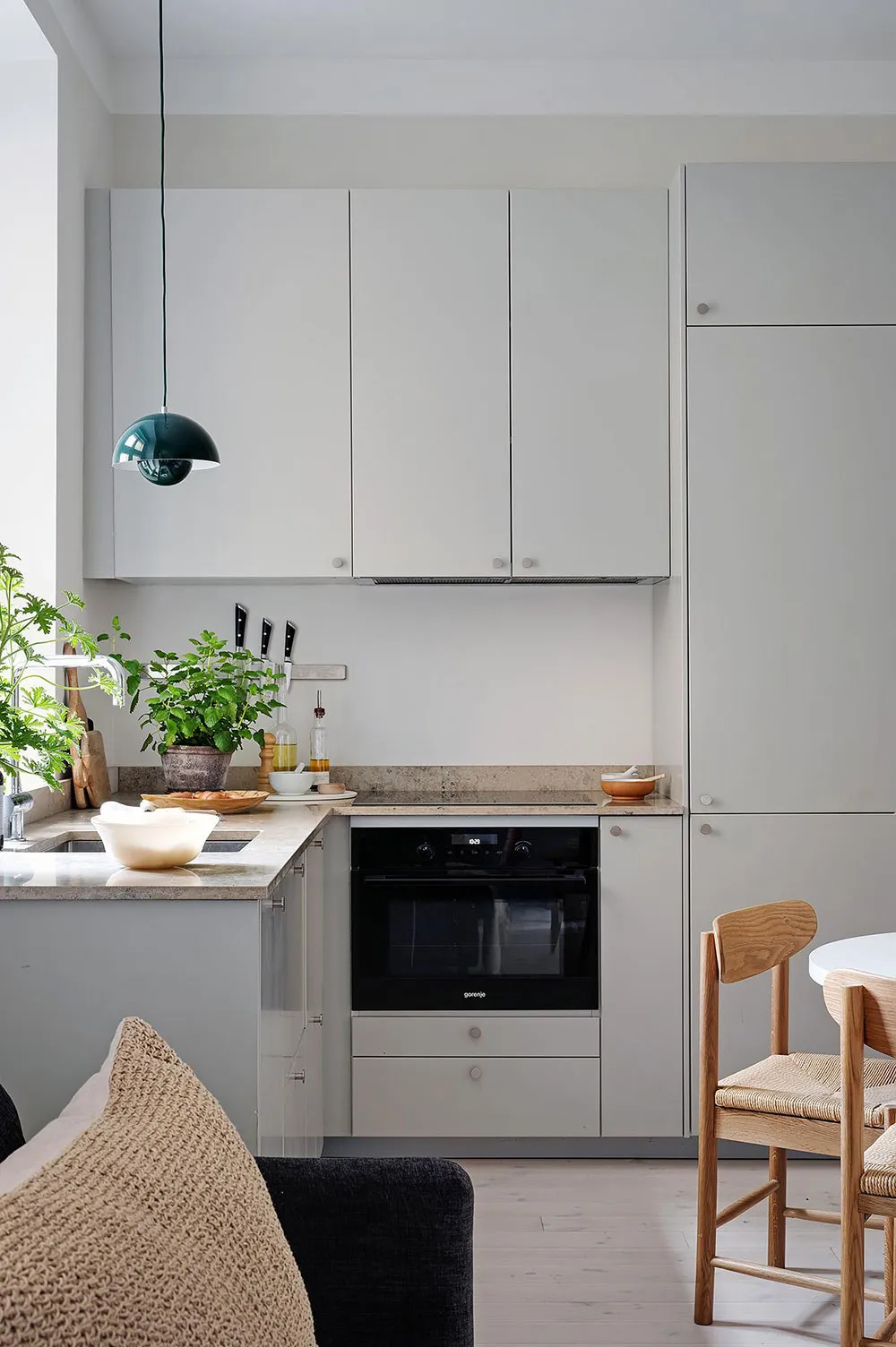 Minimalist kitchen featuring modern glass cabinets and concrete countertops.