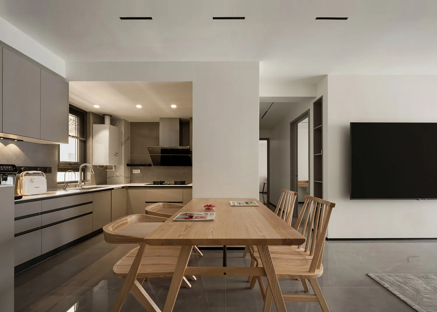 A modern kitchen with wooden furniture and a minimalist design.