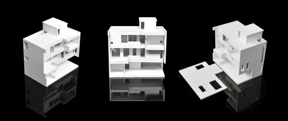 White architectural model of a modular building structure on a black reflective surface.