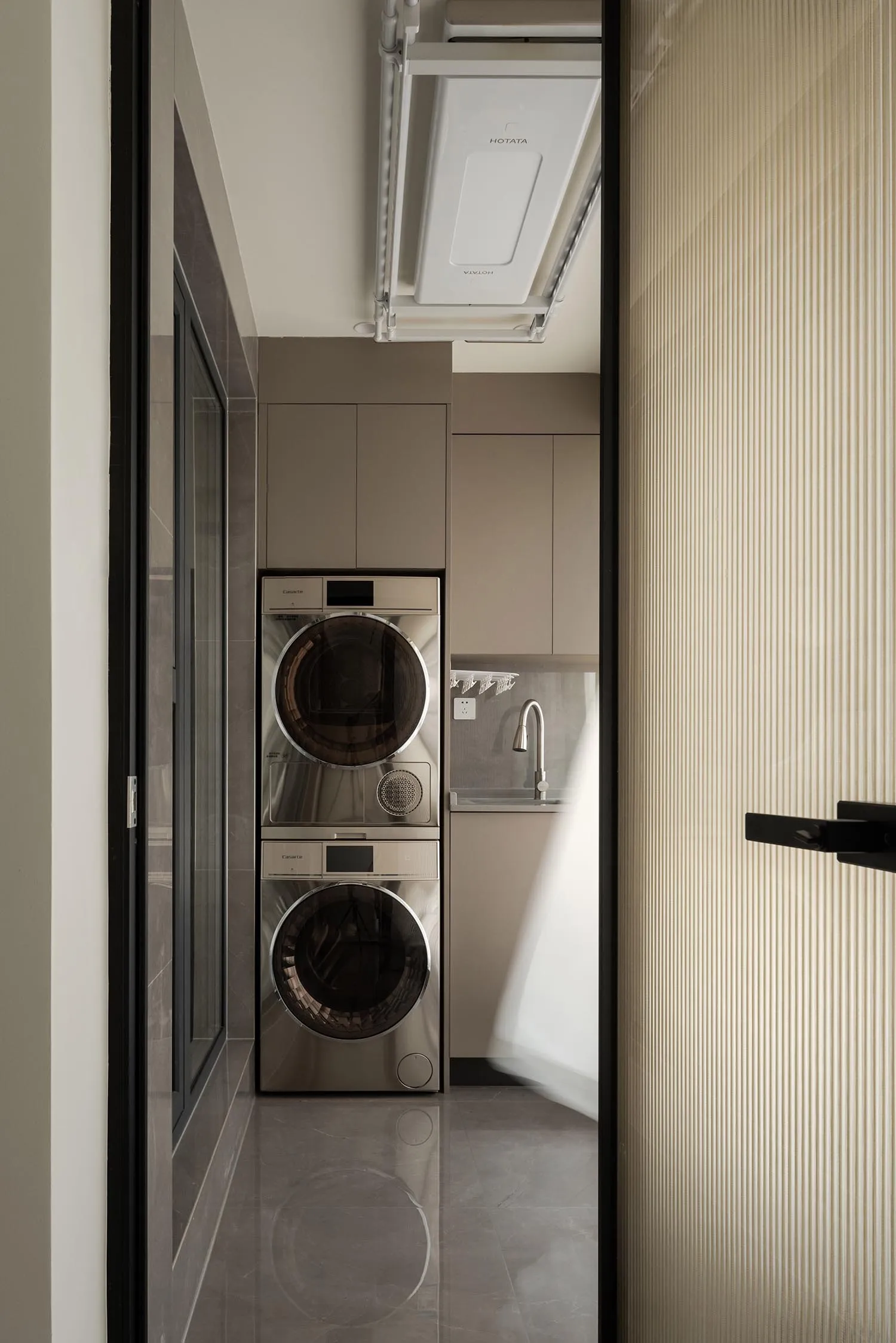 Modern laundry room with metallic washing machine and dryer