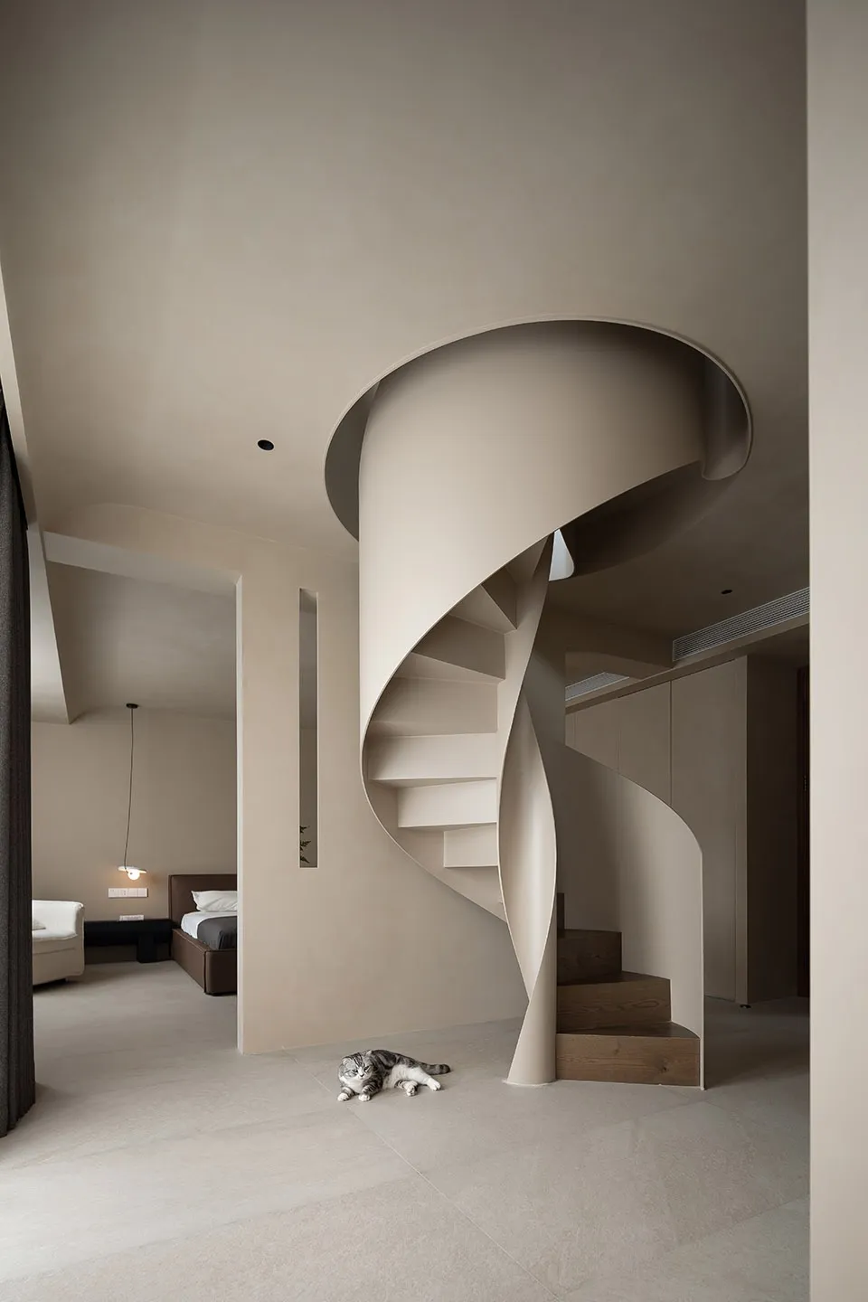 A minimalist, modern residential interior featuring a spiral staircase with light wood steps and a sleek, clean design.