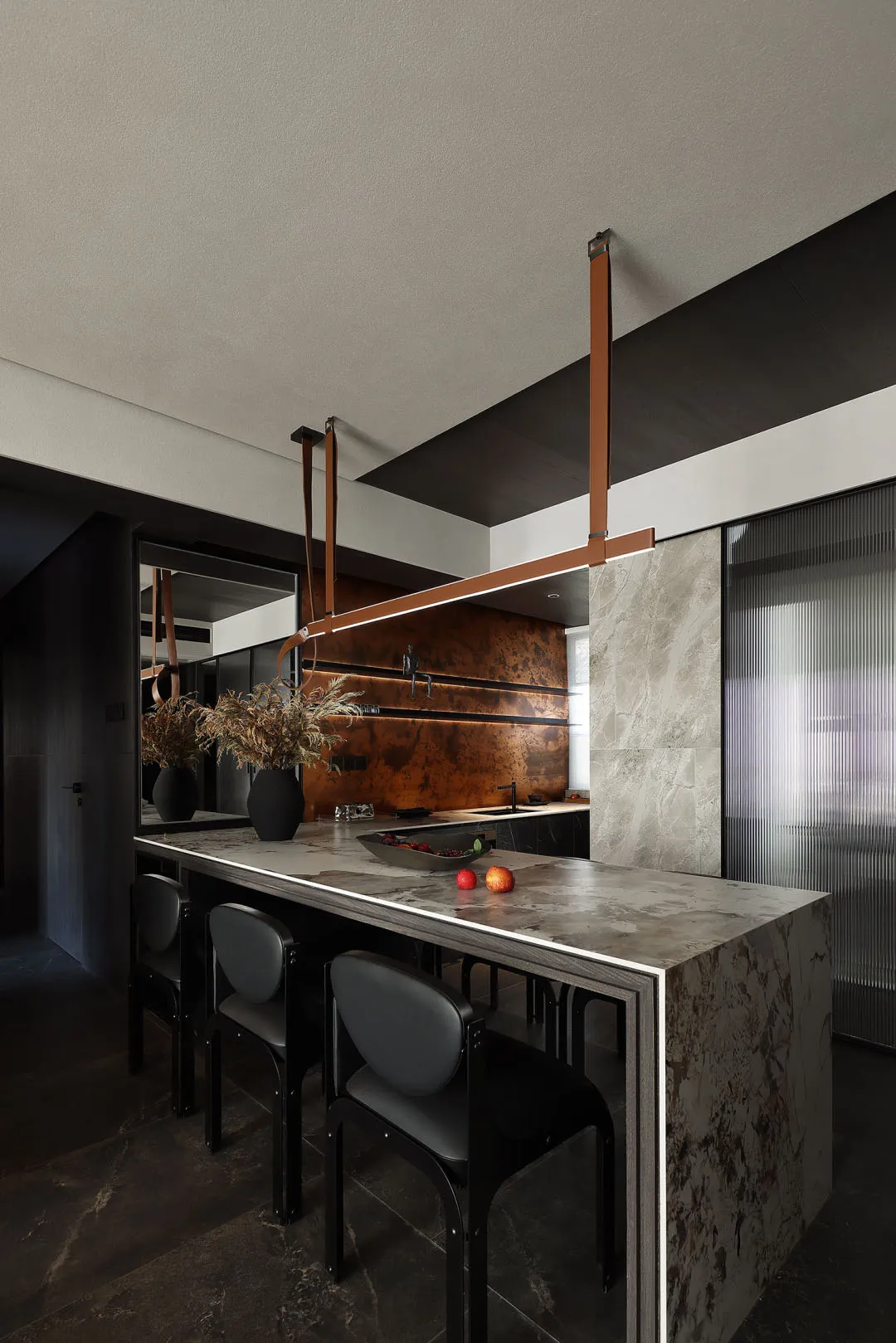 Modern kitchen featuring marble countertops and minimalist design.