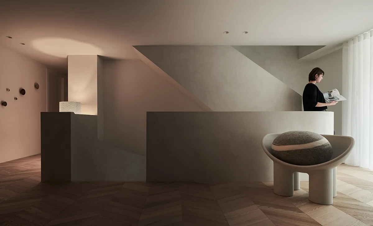 A modern, minimalist apartment featuring a concrete interior with a geometrically shaped chair.