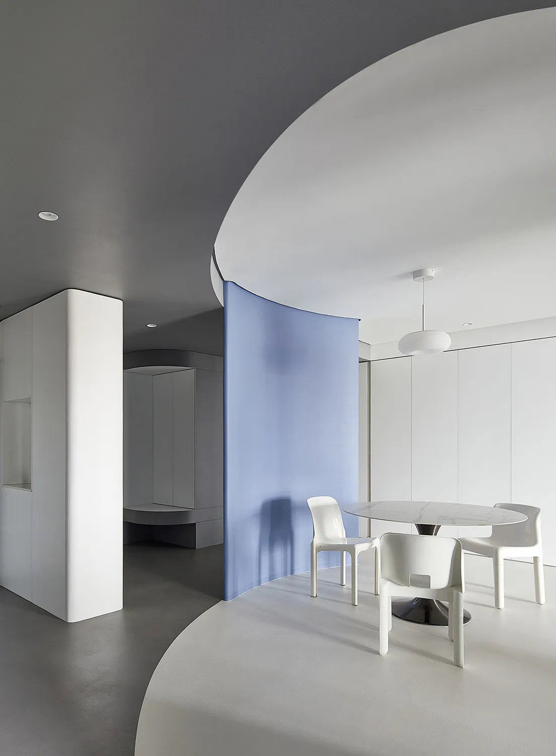 Modern minimalist interior design featuring polished concrete, white plaster walls, and glass elements.