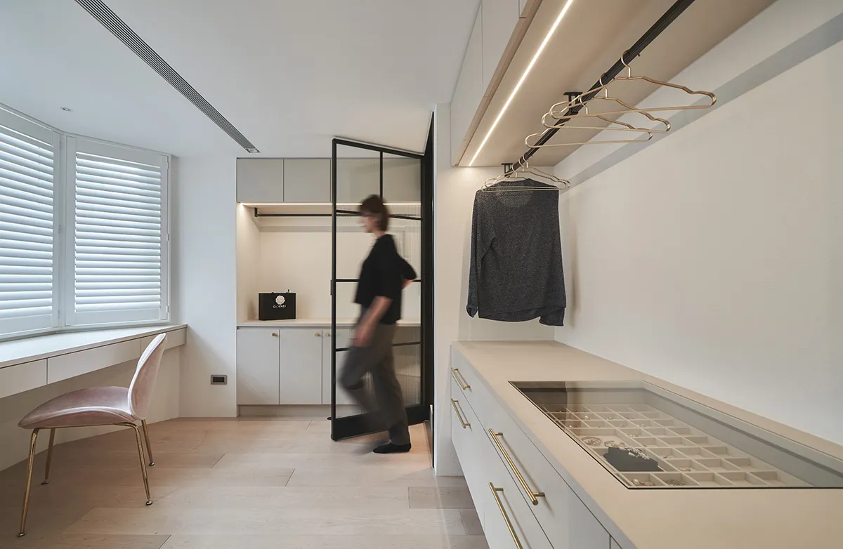 A modern wardrobe studio featuring a minimalist design with neutral materials and clean lines.