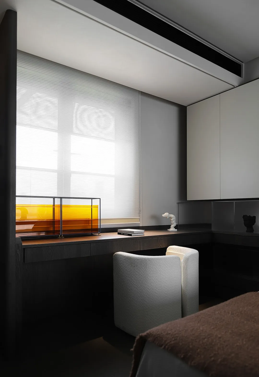 A minimalist bedroom with wooden furniture, glass panels, and metal accents.