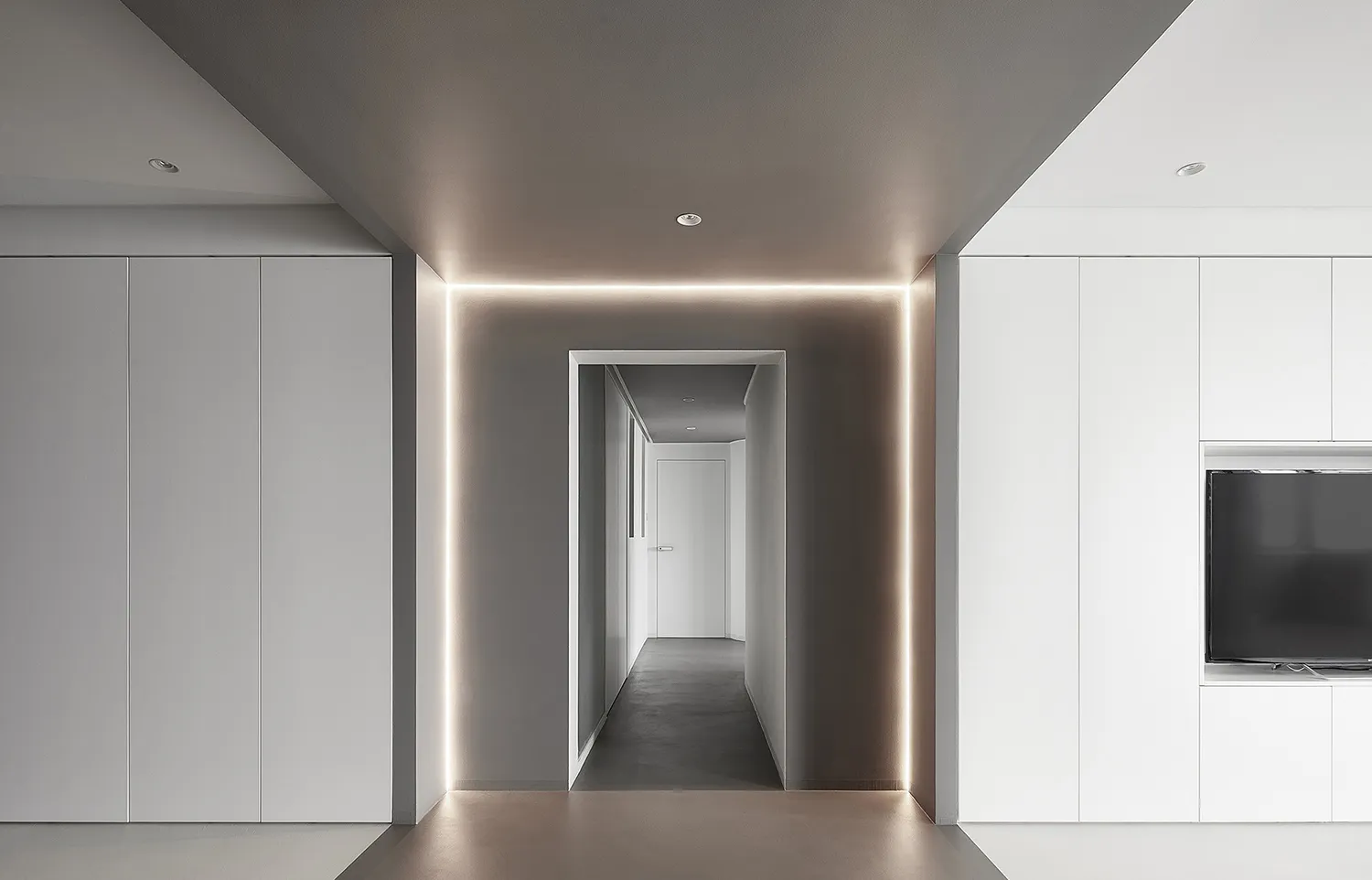 A modern, minimalist interior design featuring a concrete floor and white walls.
