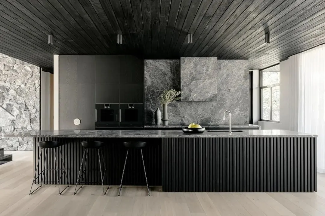 a modern residential kitchen featuring stone and marble elements