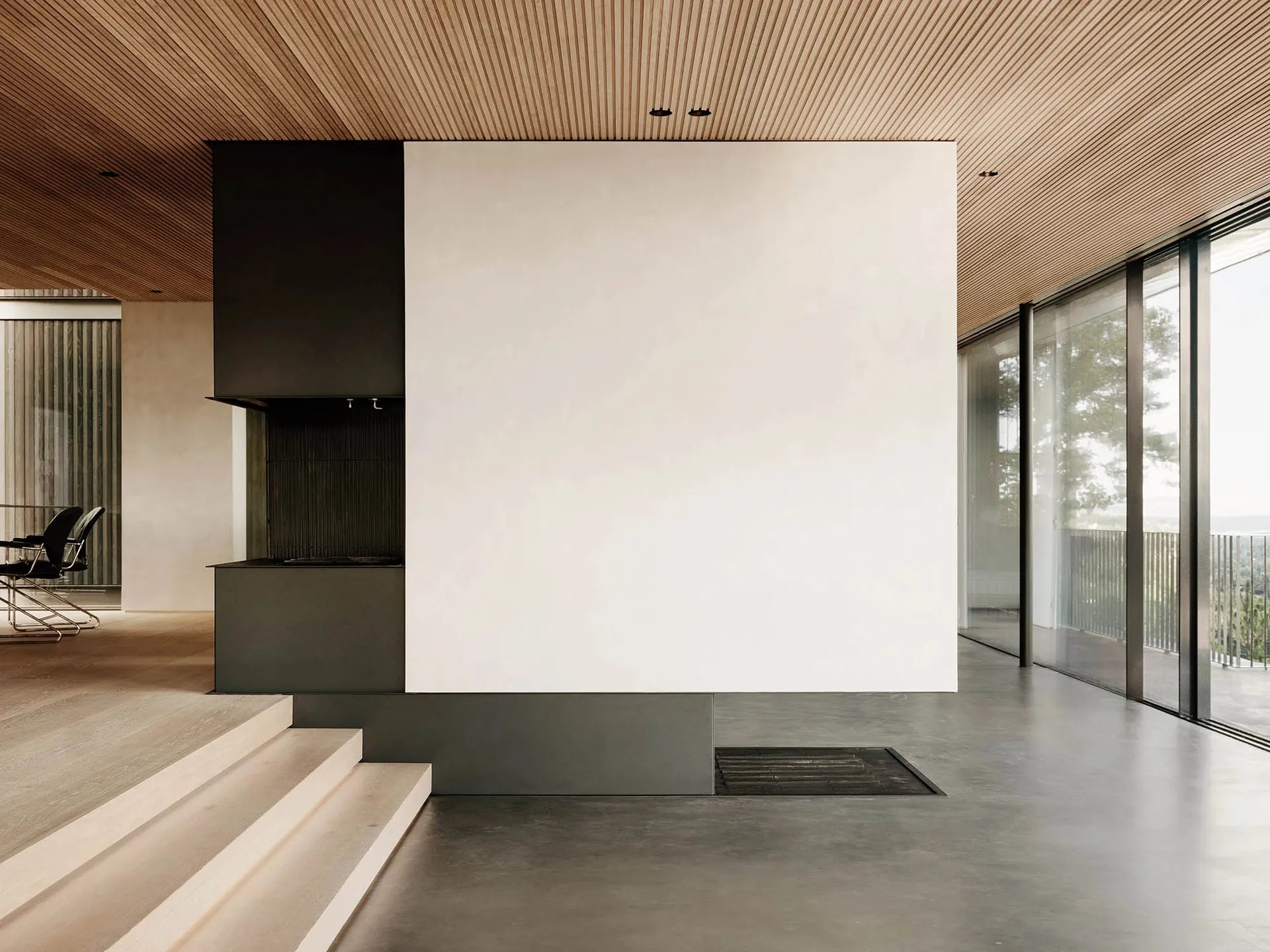 Modern minimalist living room with concrete and wood materials