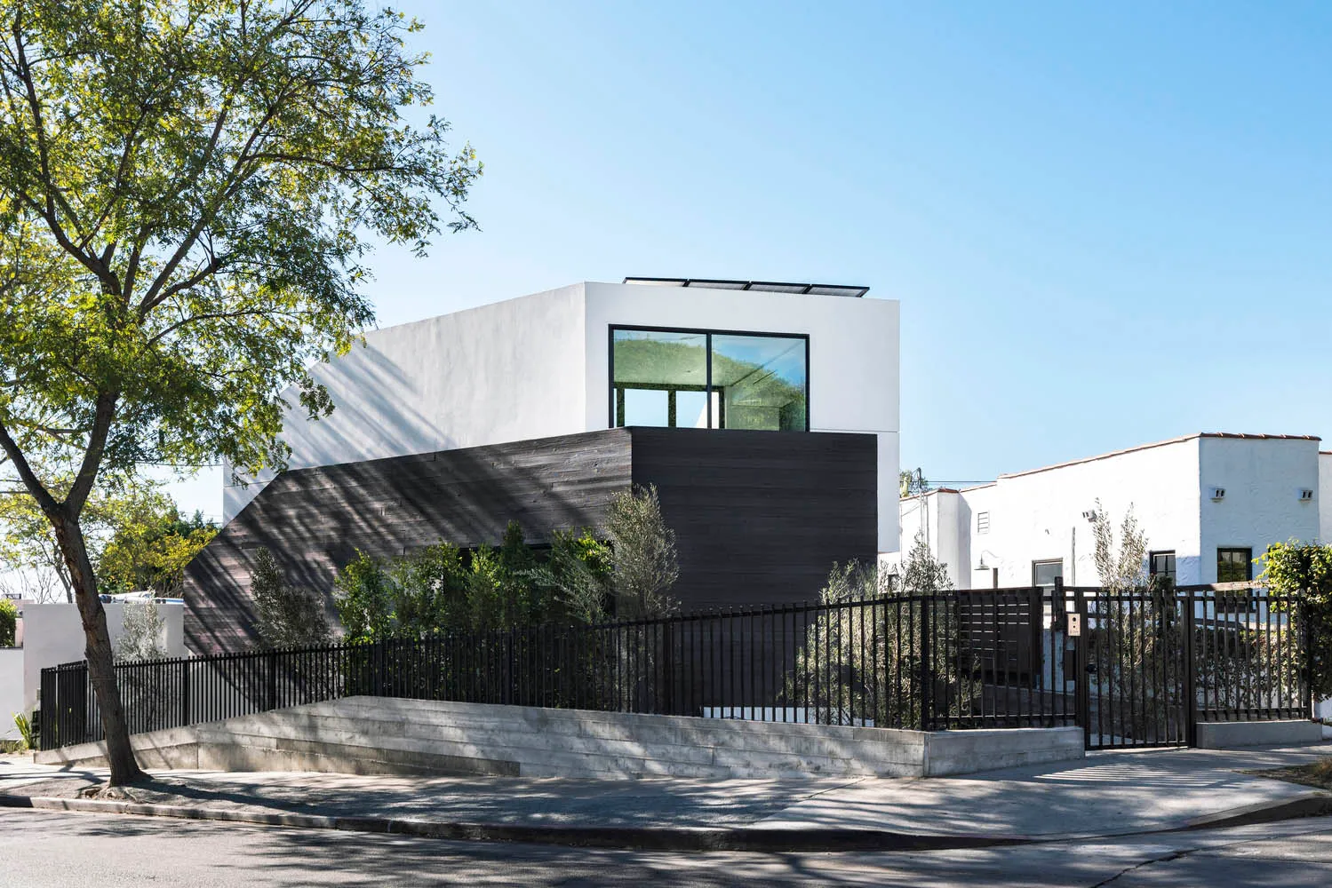 A modern metallic house with large windows and a minimalist design.