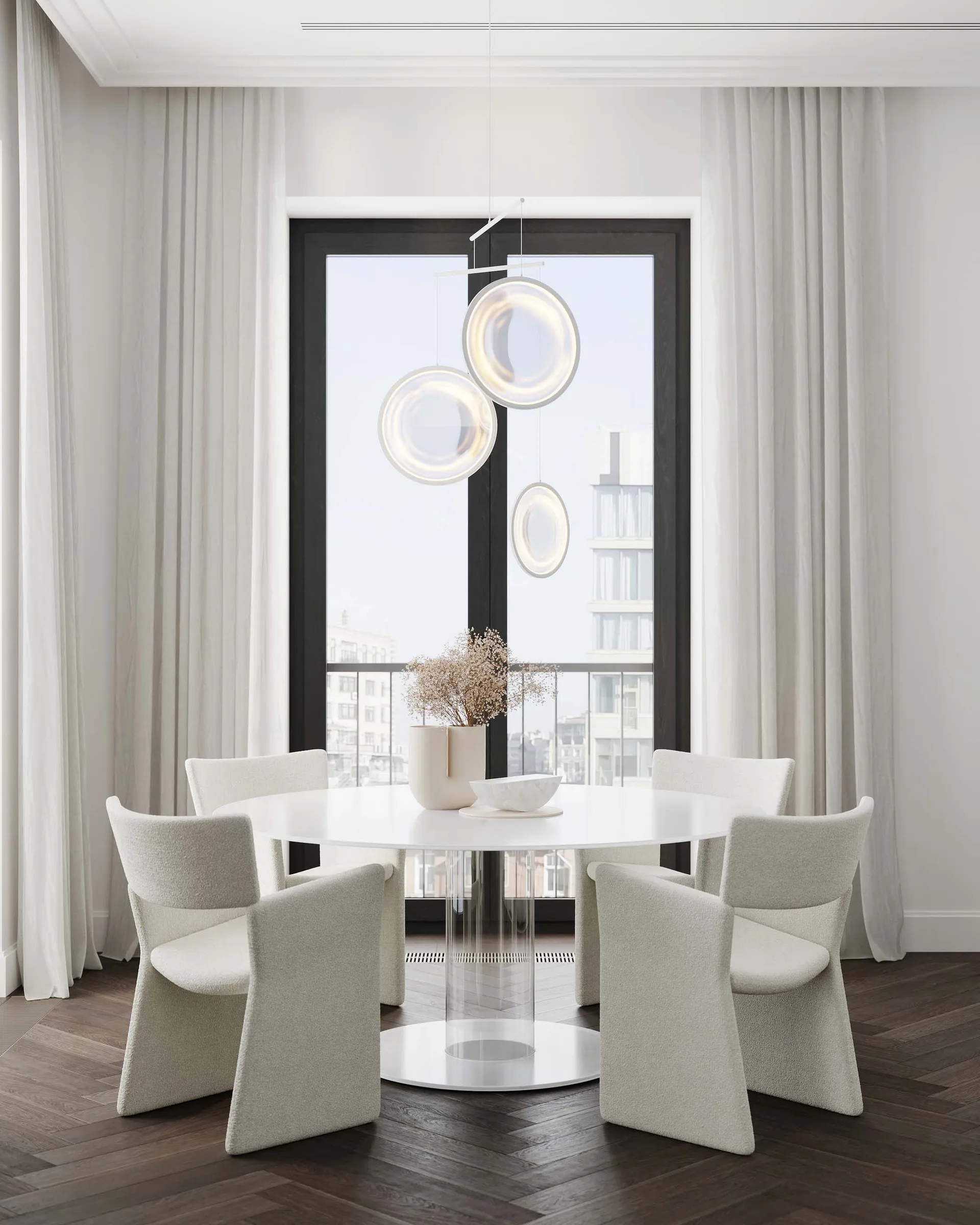 Modern dining room featuring fabric chairs, a glass table, and wooden flooring.