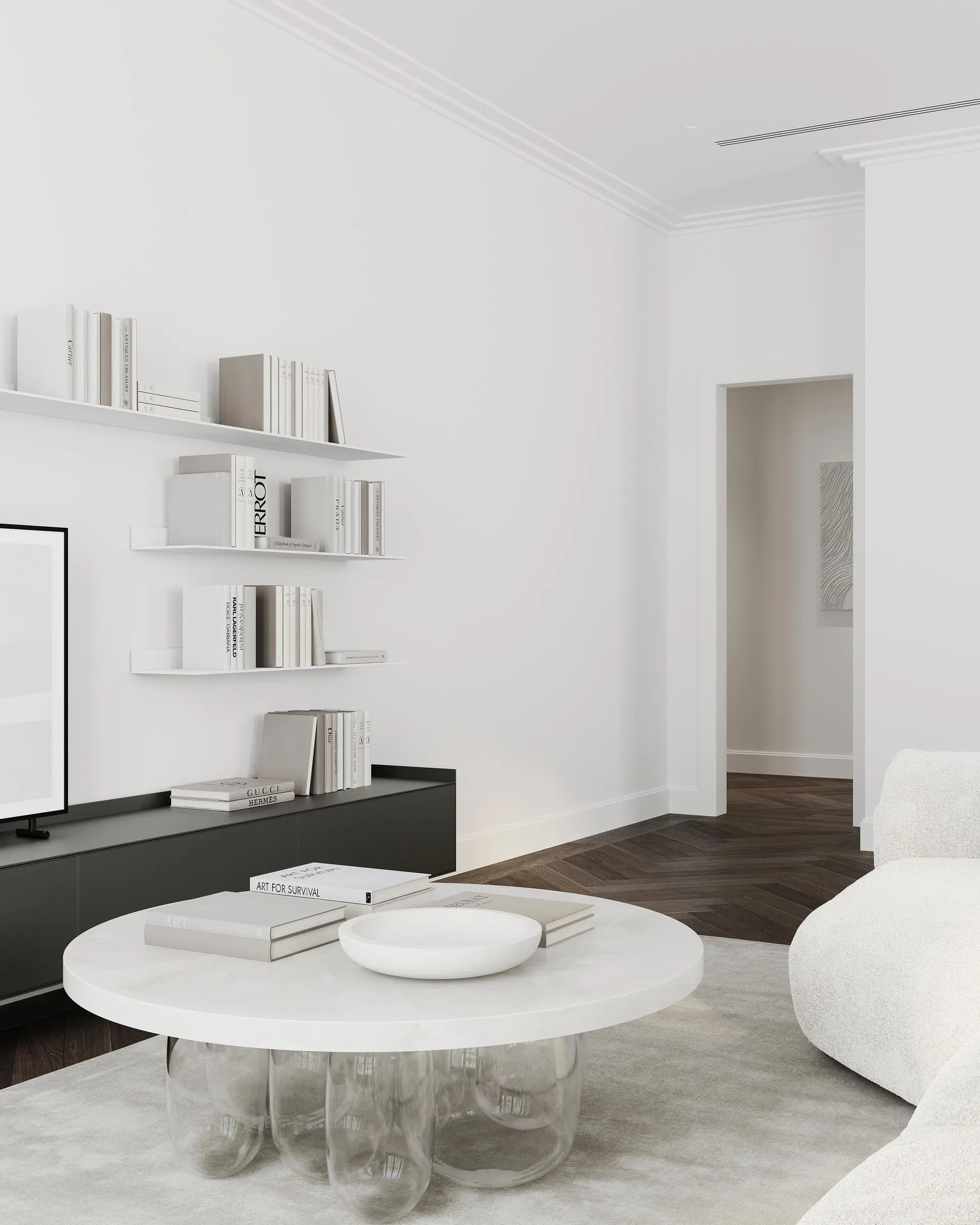 A minimalist living room with a white marble table, glass spherical legs, and black floating shelves.